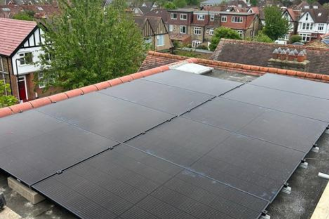 Solar Panels fitted on a flat concret roof. - Solar Panel Installers UK