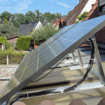 Solar Panels on a flat roof using a cable. - Solar panels installed in a London home.