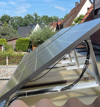 Solar Panels on a flat roof using a cable. - Solar panels installed in a London home.