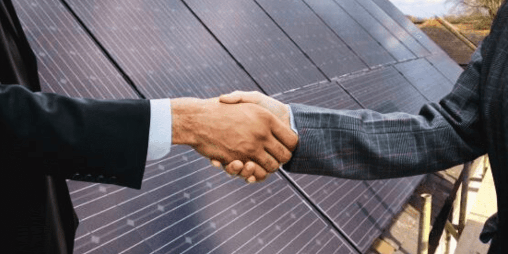 Two people shaking hands - solar panel installers UK