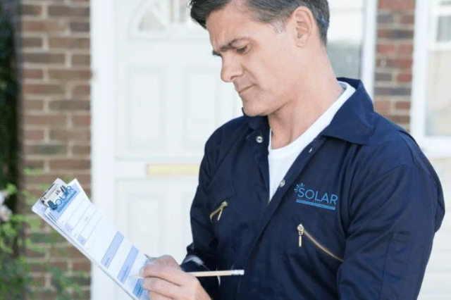 solar panel installers UK surveyor Preparing Estimate For a solar panel installation On House