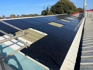 Black Solar Panels Fitted To Metal Commercial Roof In Norfolk. Solar Panel Installers Norwich