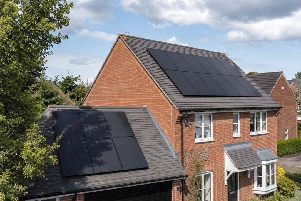 All-black-solar-panels-on-a-UK-home-receiving-different-levels-of-sunlight-and-partial-tree-shading.png